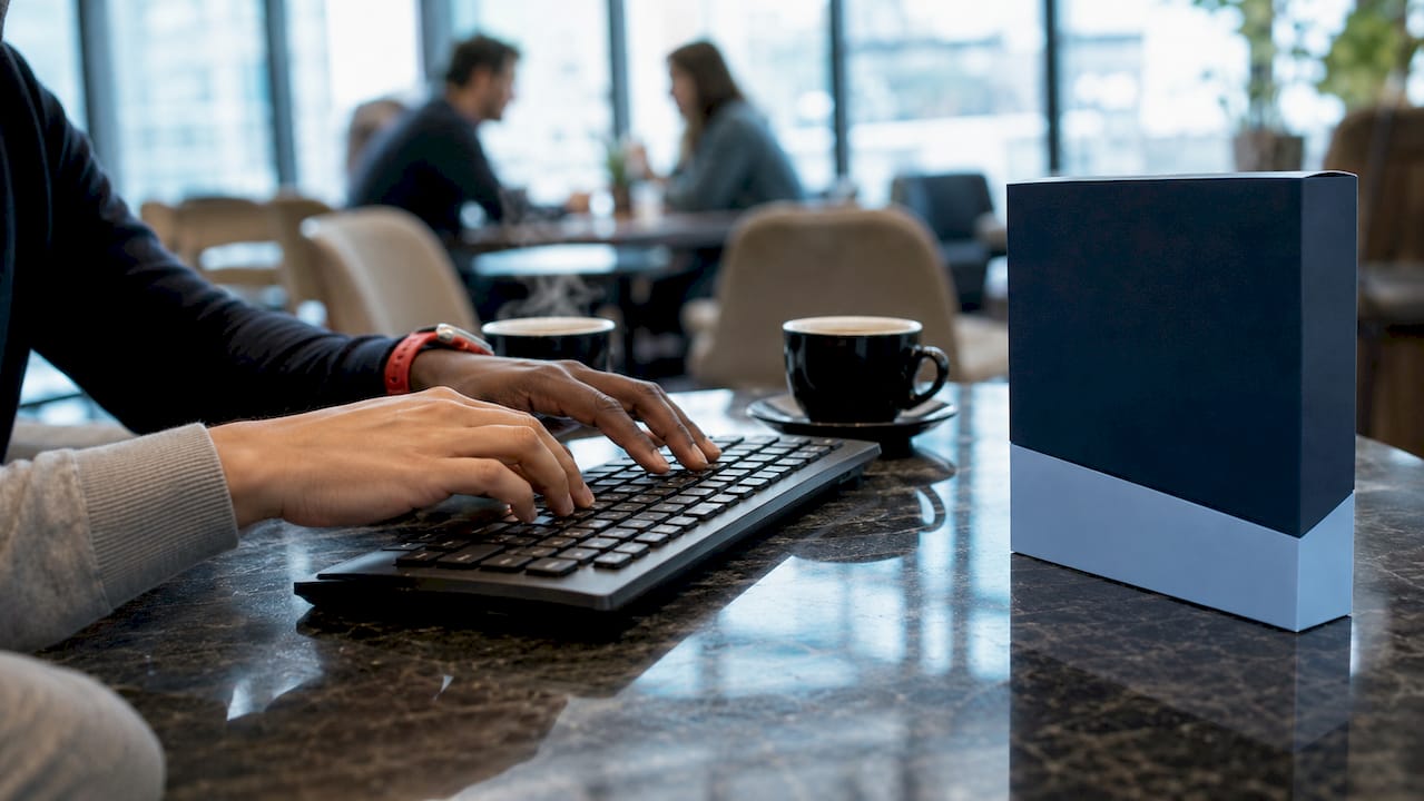 Hands typing near Windows Server Essentials box