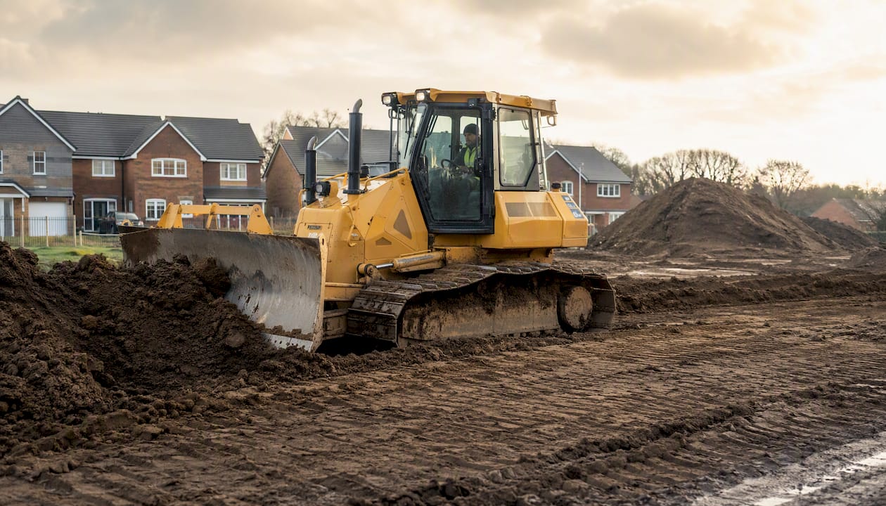 Bulldozer grading soil during earthworks