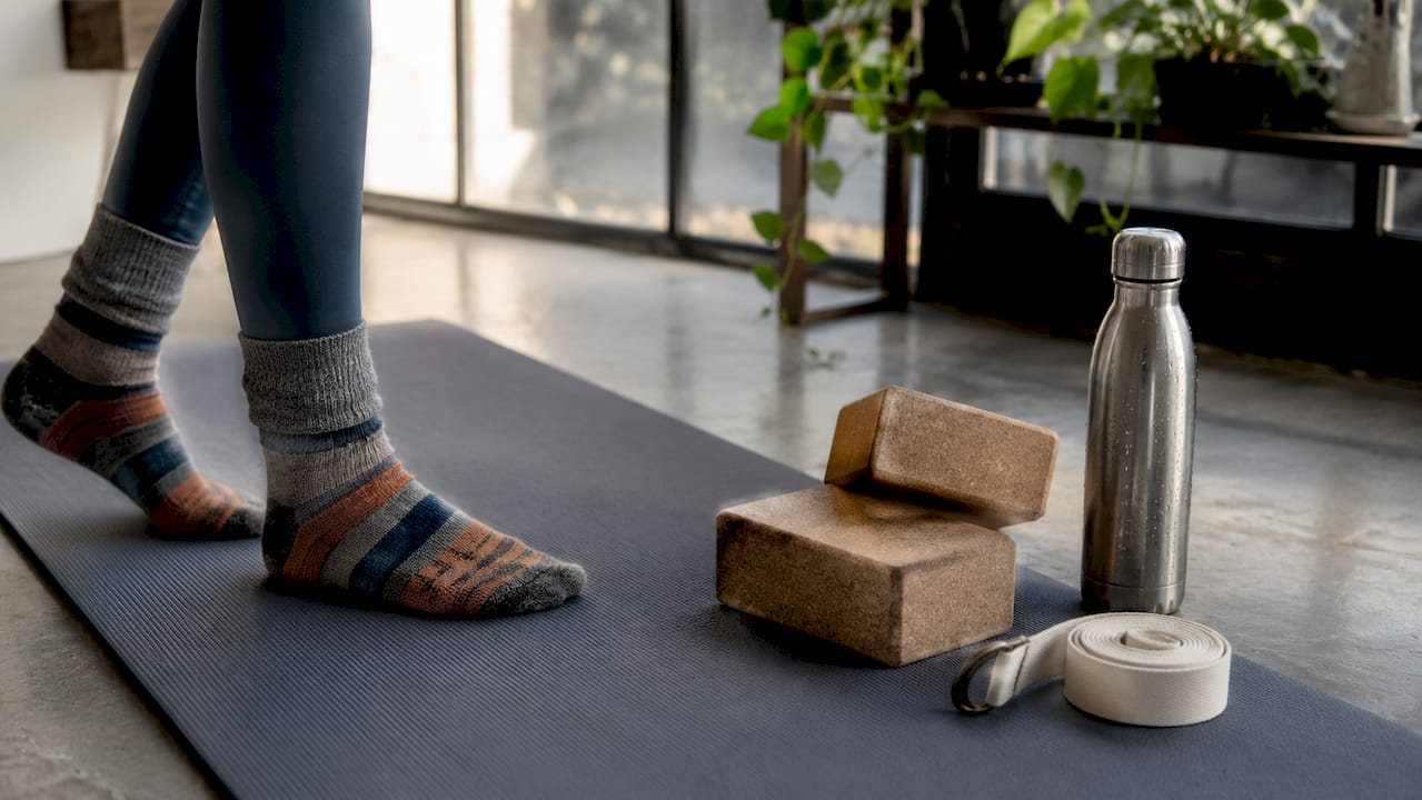 Top-down view of yoga mat with blocks and strap