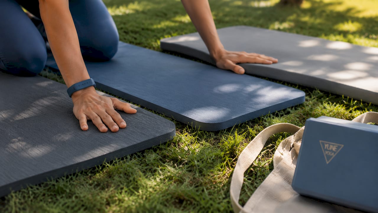 Hands pressing different yoga mat materials