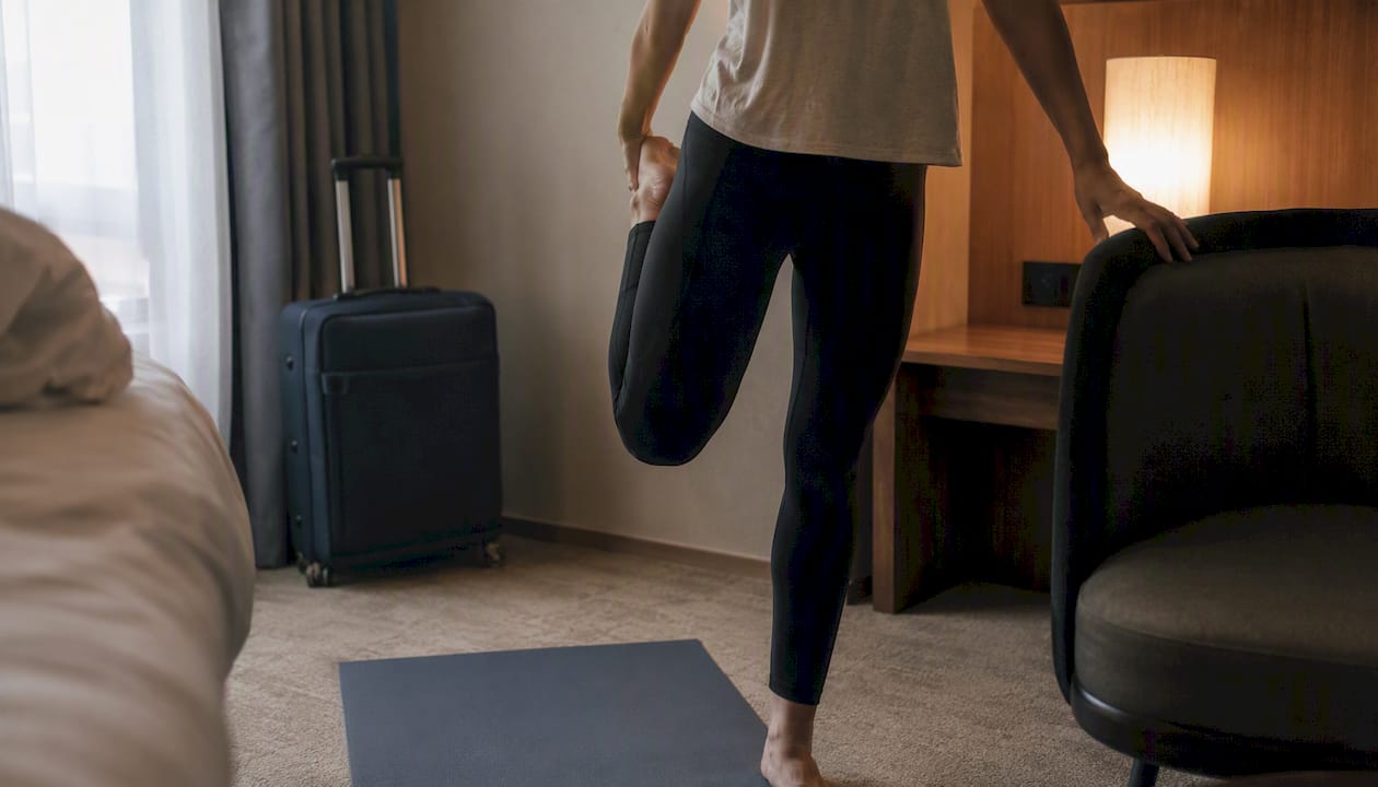 Overhead of hotel room yoga setup with balance support