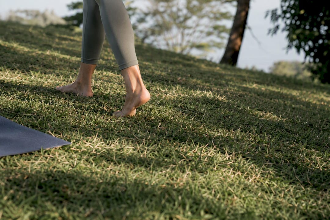 Bare feet checking a grassy yoga spot