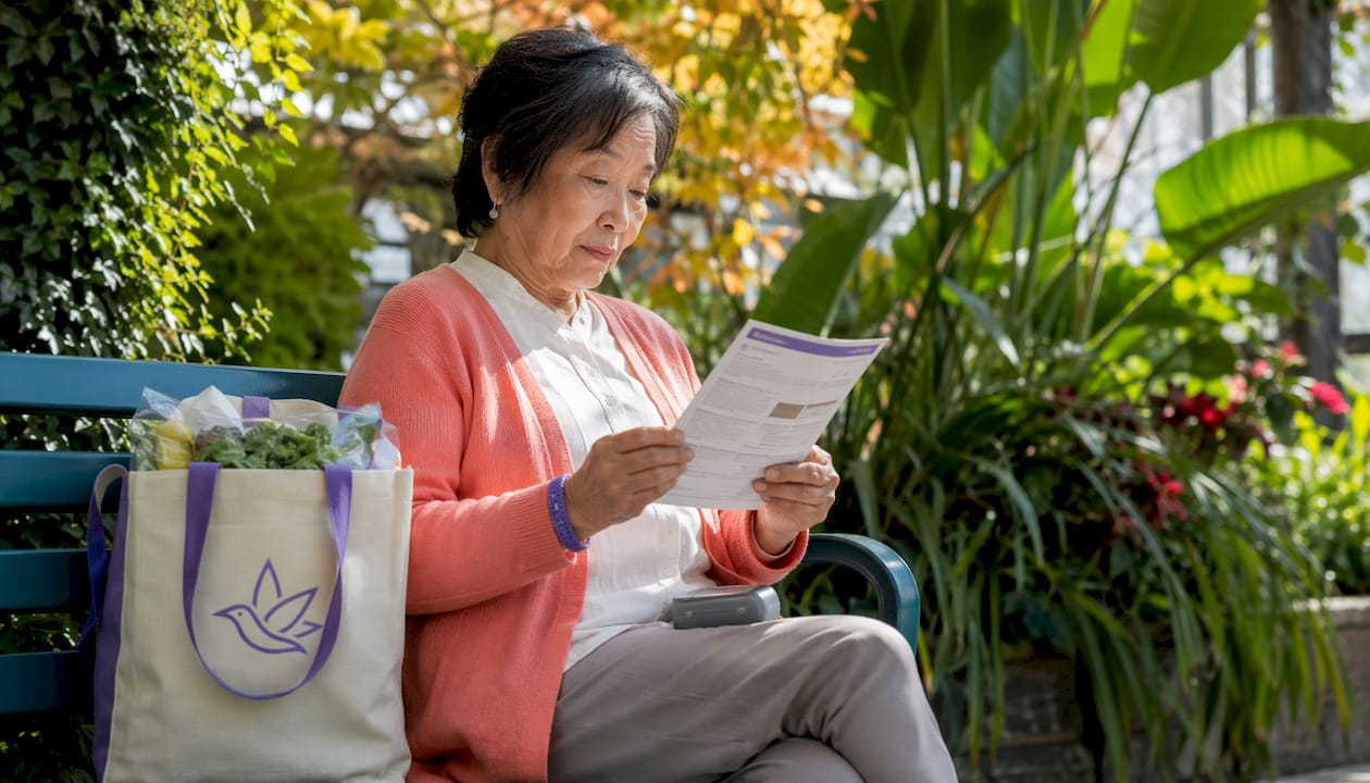 Woman reading Ontario cannabis vaping rules outdoors