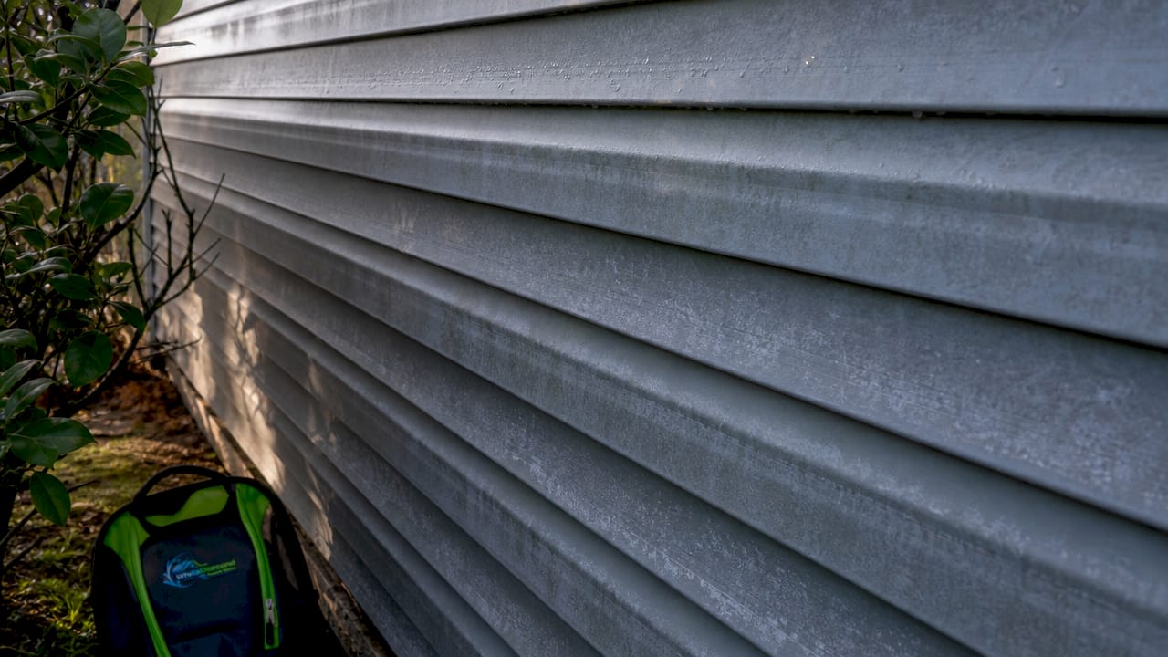 Close-up of oxidized aluminum siding texture