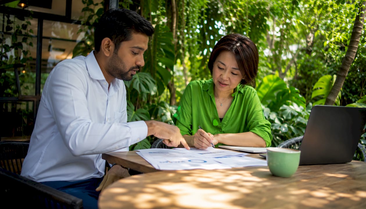 Small business owner consulting with auditor in meeting room
