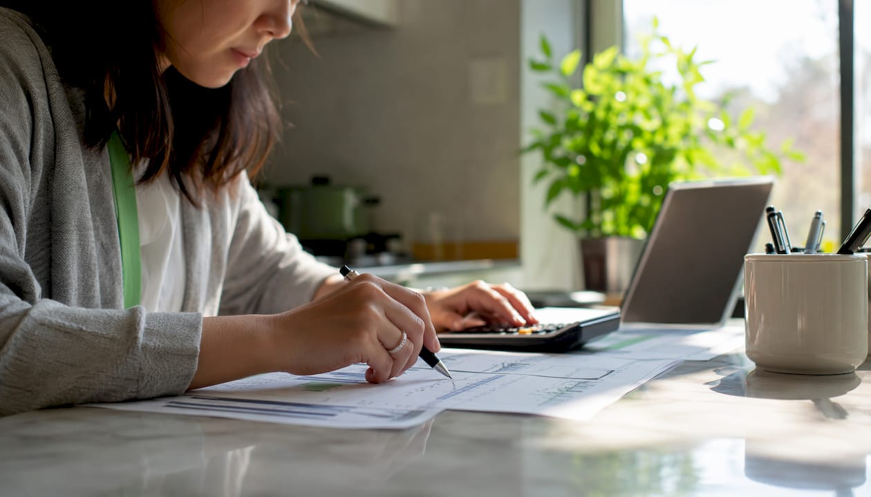 Hands calculating Value at Risk on financial report