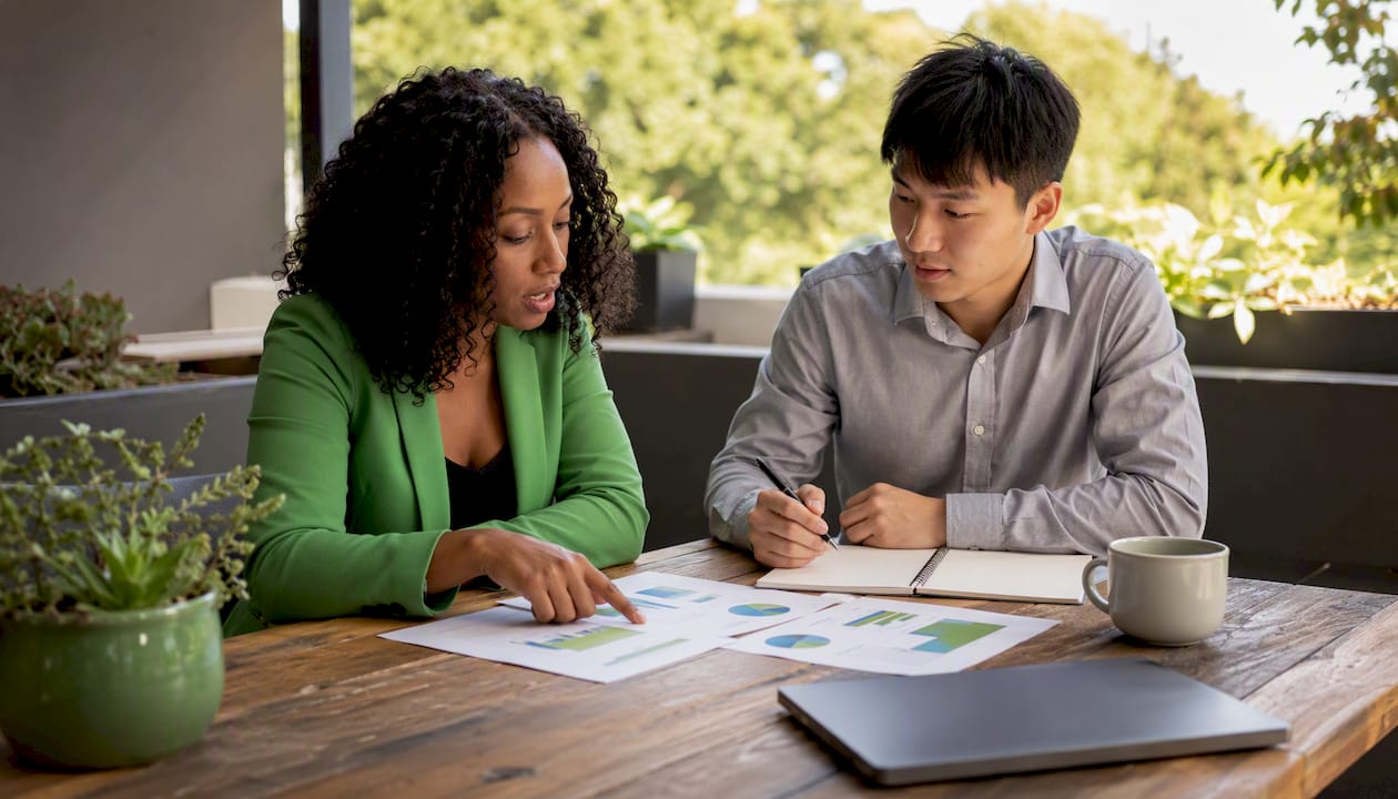Two professionals discussing inventory valuation papers