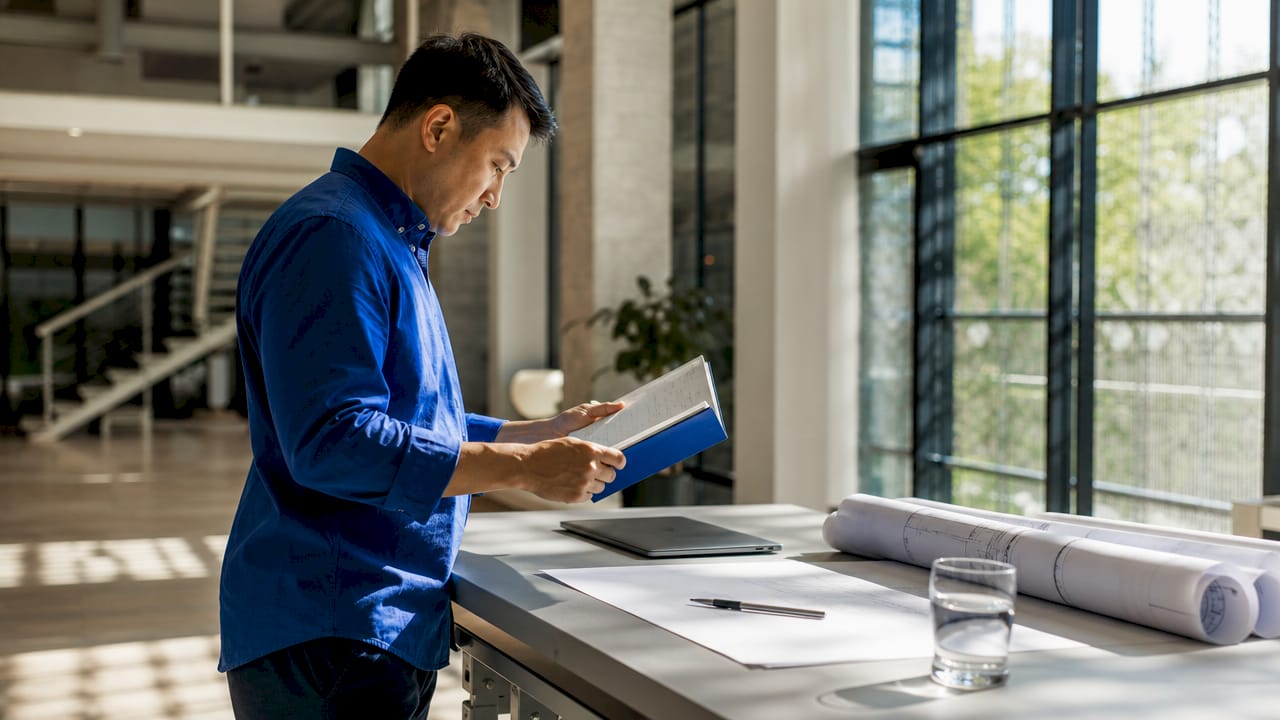 Architect working on Revit project info at desk