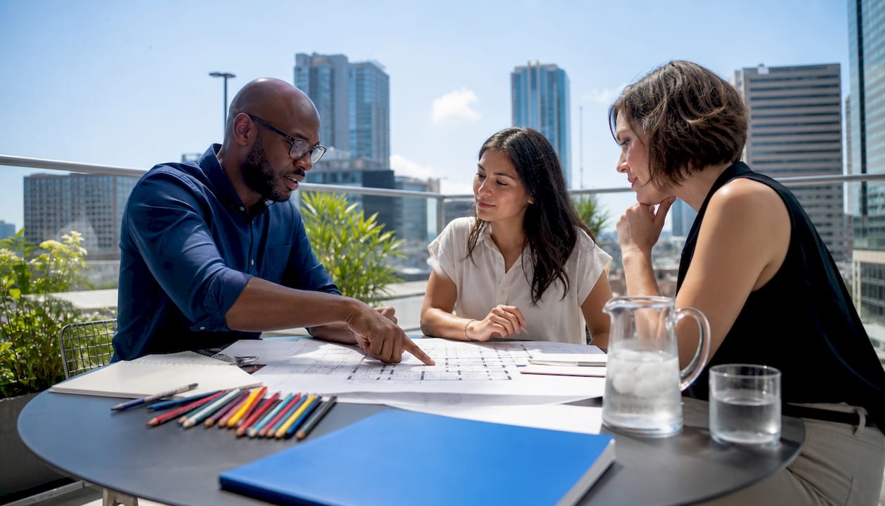 Architects collaborating around table in meeting room