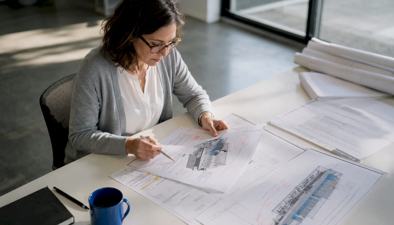 BIM manager reviewing ISO 19650 documents at desk