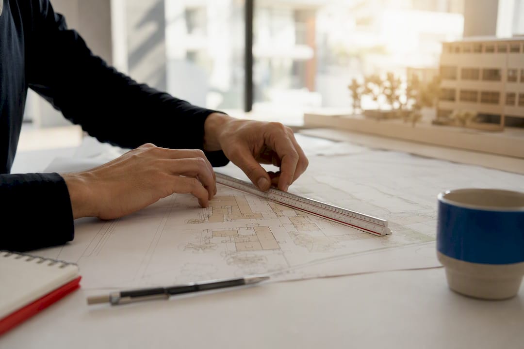 Hands setting site coordinates with scale and stylus