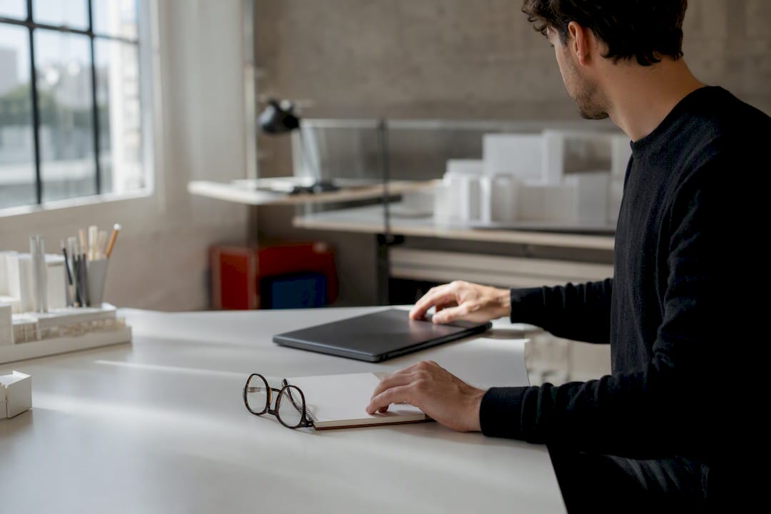 Architect's hands organizing exam study tools