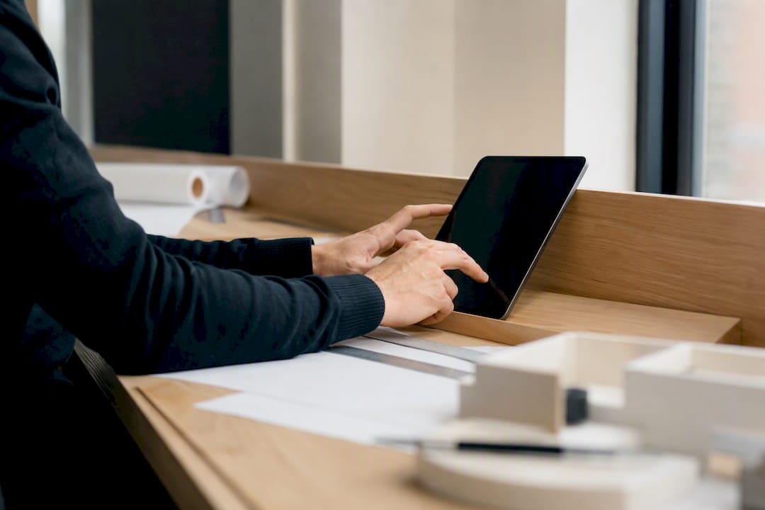 Hands editing external keynote text file on tablet