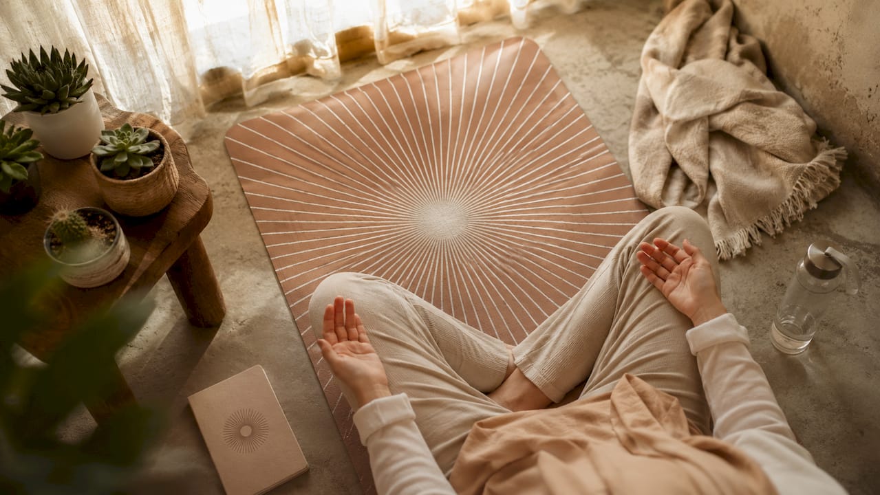 Close-up of hands during breathwork on yoga mat
