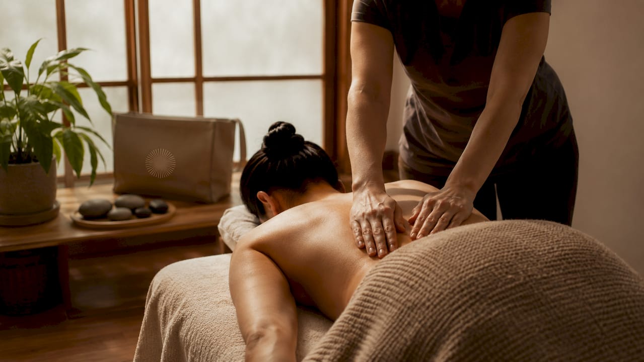 Massage therapy hands in tranquil treatment room