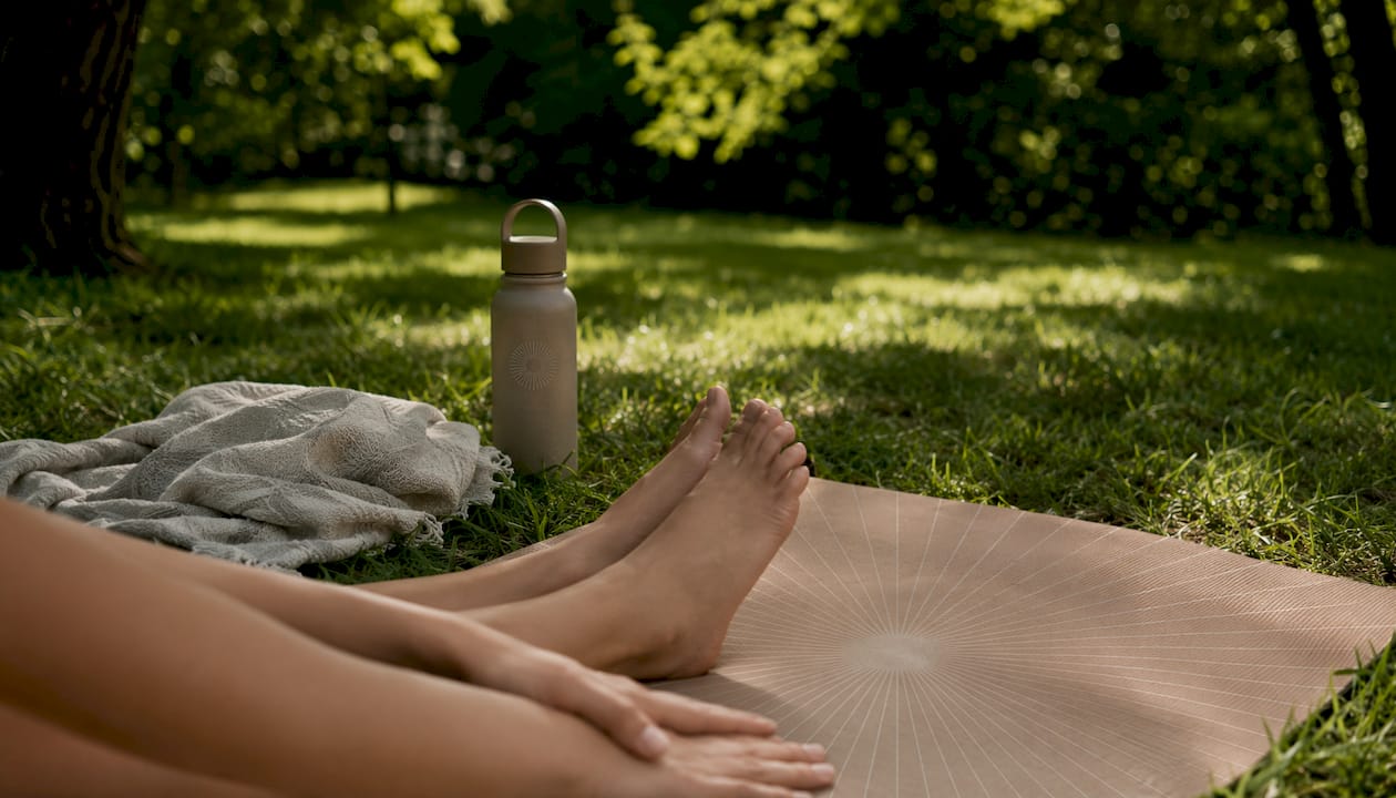 Close-up of yoga mat and hands in stretching pose
