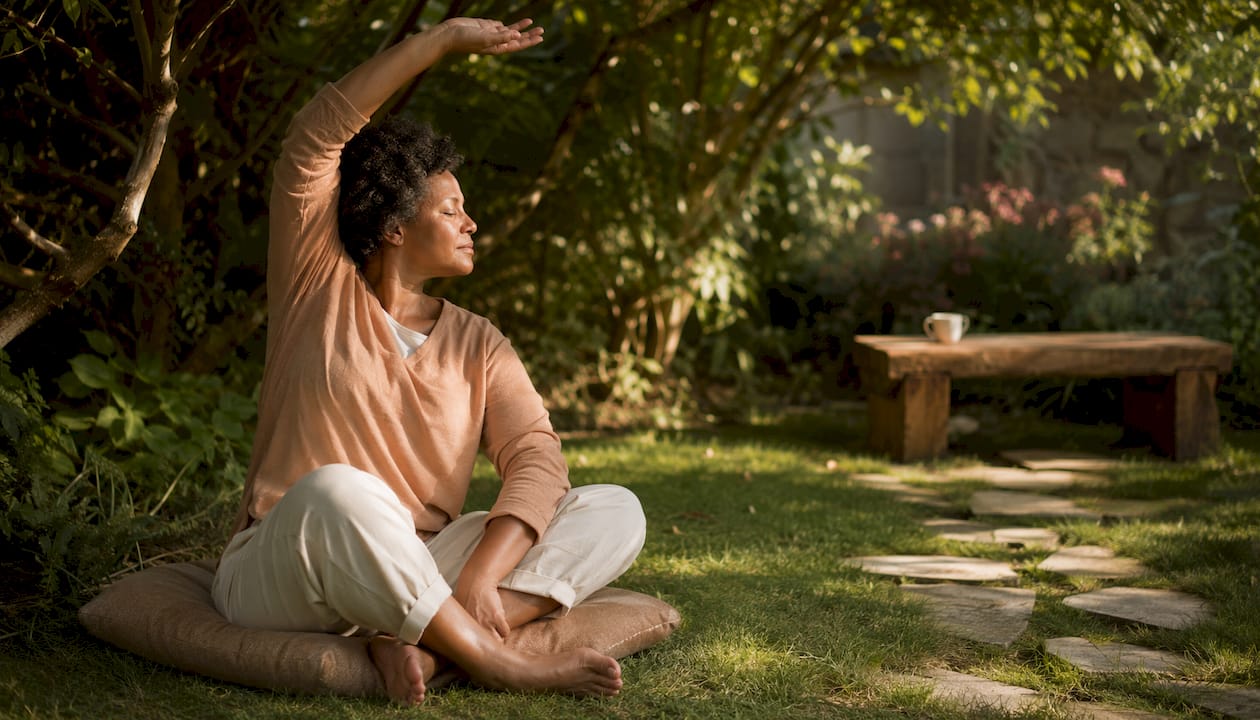 Person stretching in sunlit living room during therapy