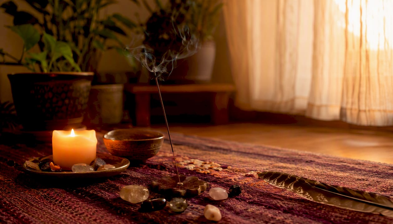 Candle and crystals on meditation altar
