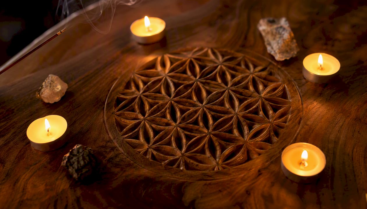 Warm candlelit Flower of Life pattern on wood