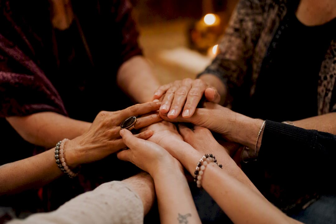 Hands touching in healing circle gesture