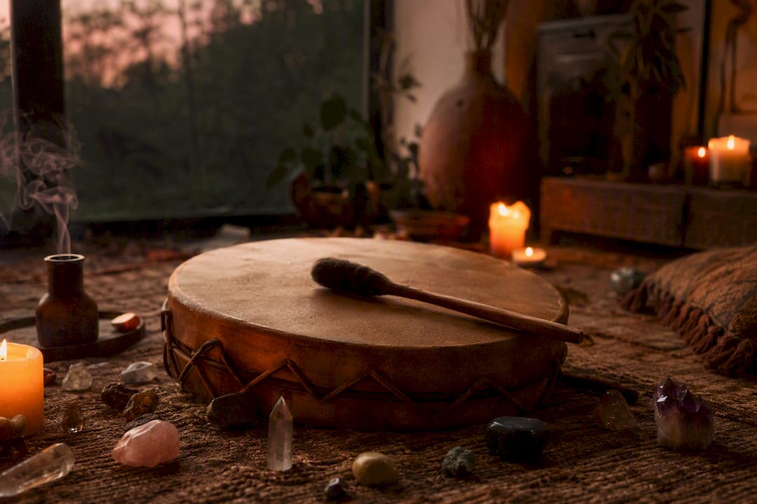 Shamanic drum on altar with candlelight