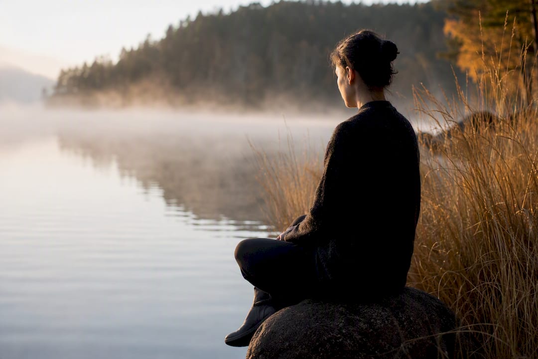 Person sitting quietly during breathing outdoors