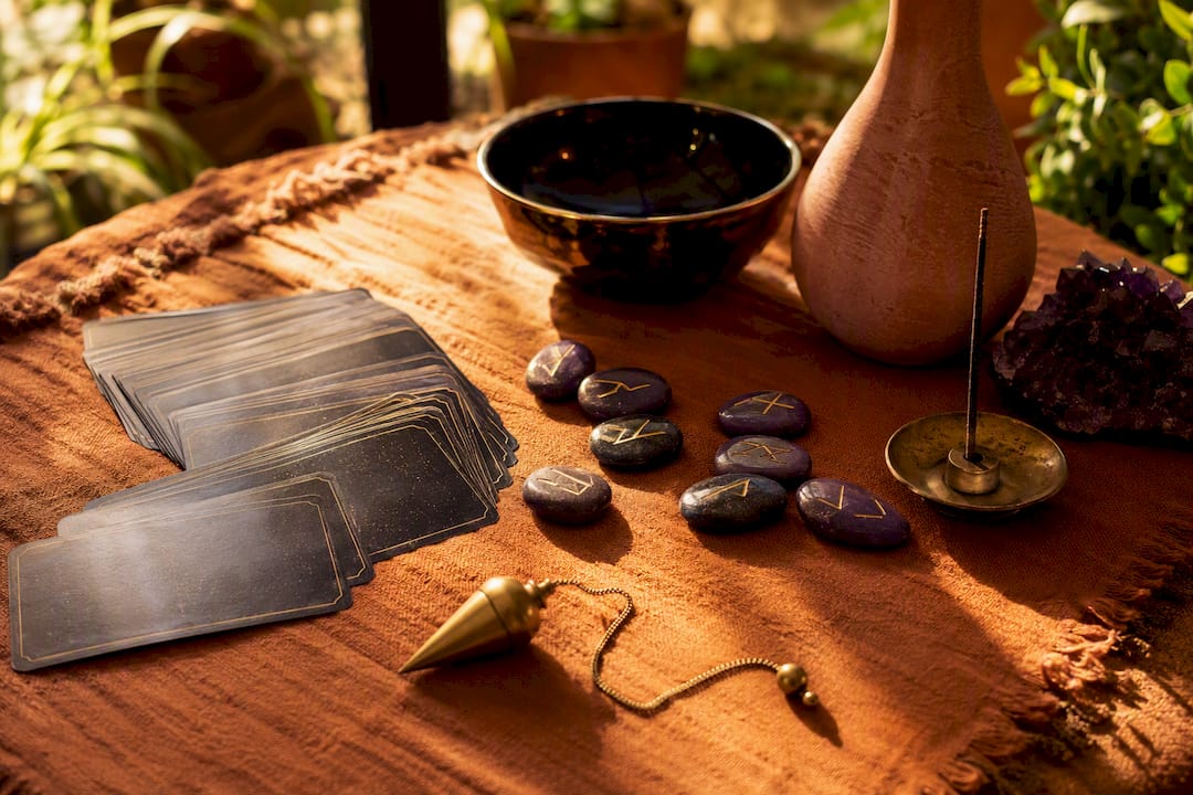 Divination tools arranged in warm sacred light