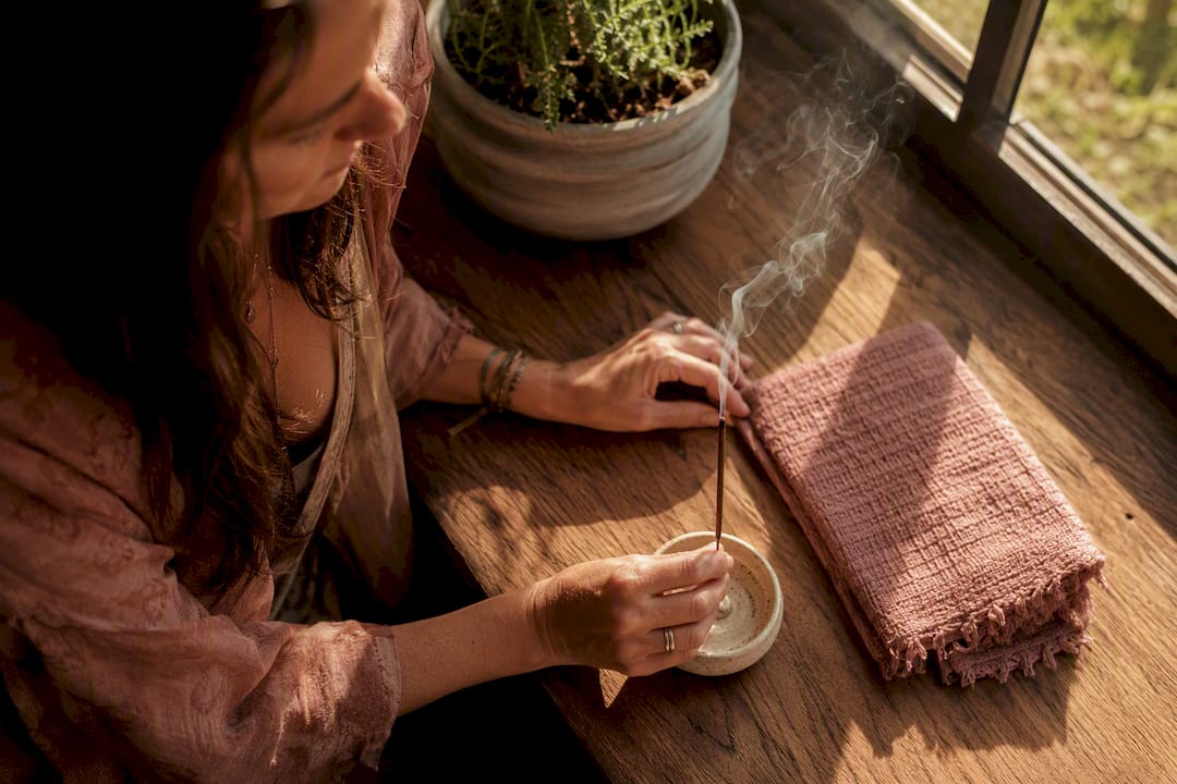 Person choosing incense as a calming ritual anchor