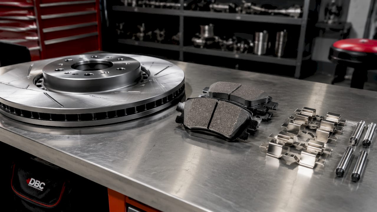 Close-up of rotors, pads, and hardware on workbench