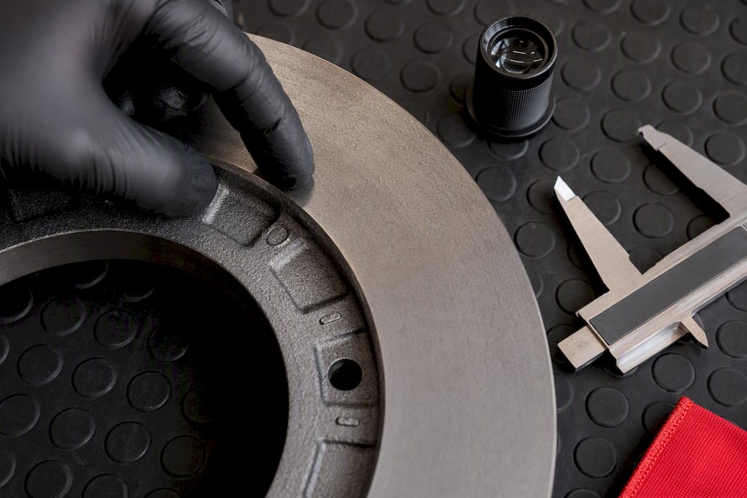 Technician inspecting brake rotor casting marks