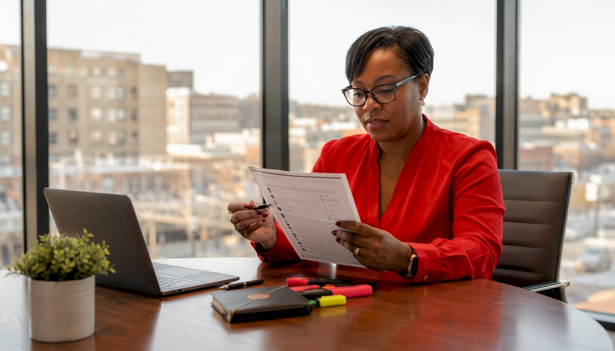 Property manager reviewing security checklist at office table