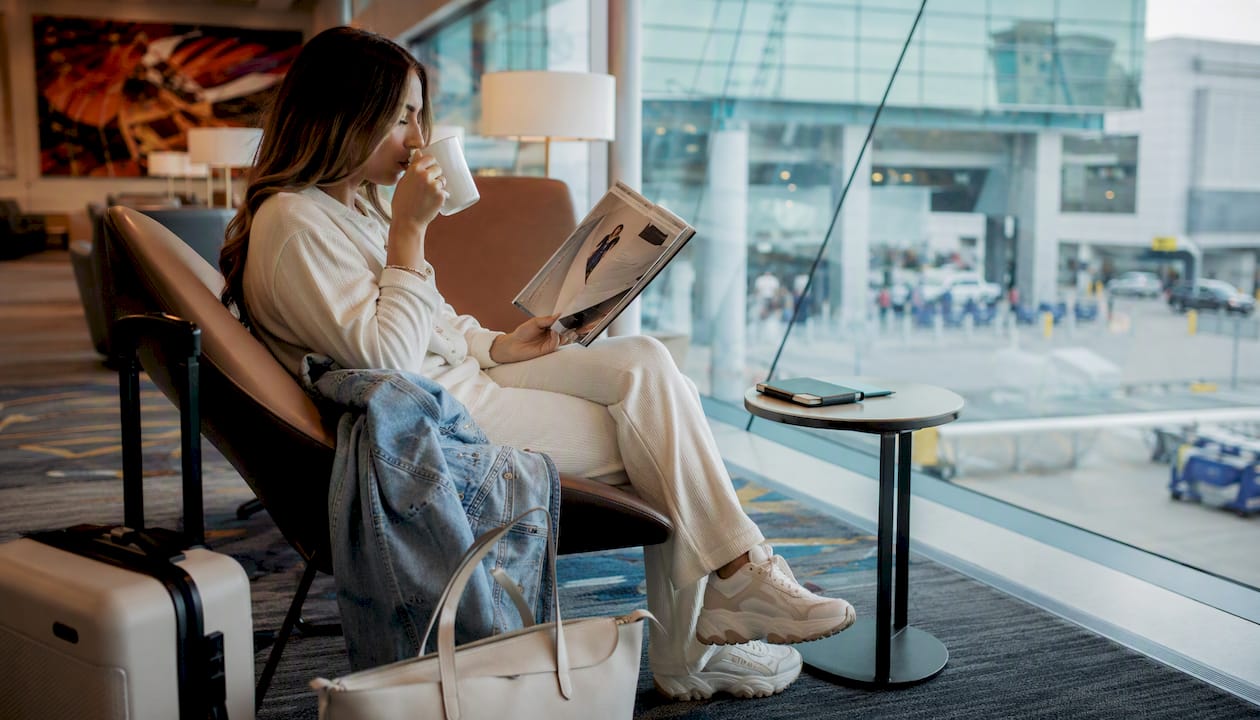 Man in travel outfit resting at airport lounge