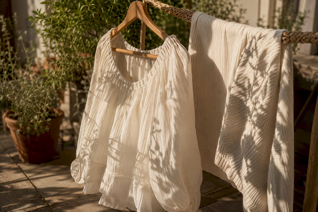 Cotton garments air drying on hanger and flat rack
