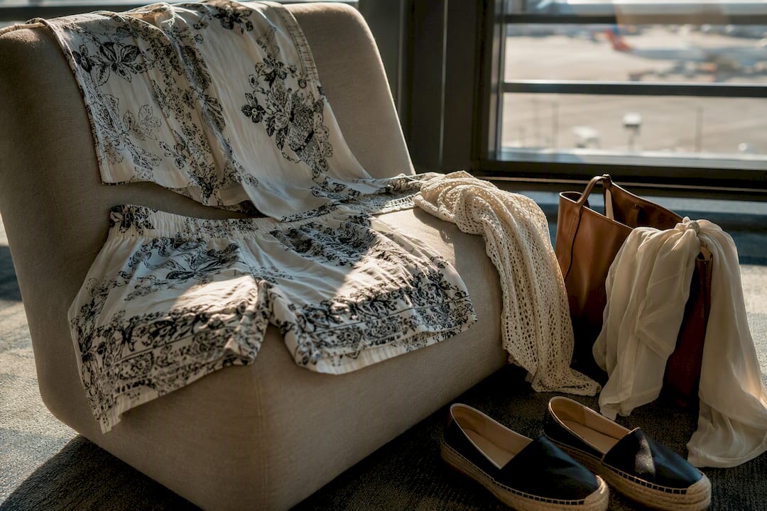 Breathable summer travel outfit laid out on airport seat