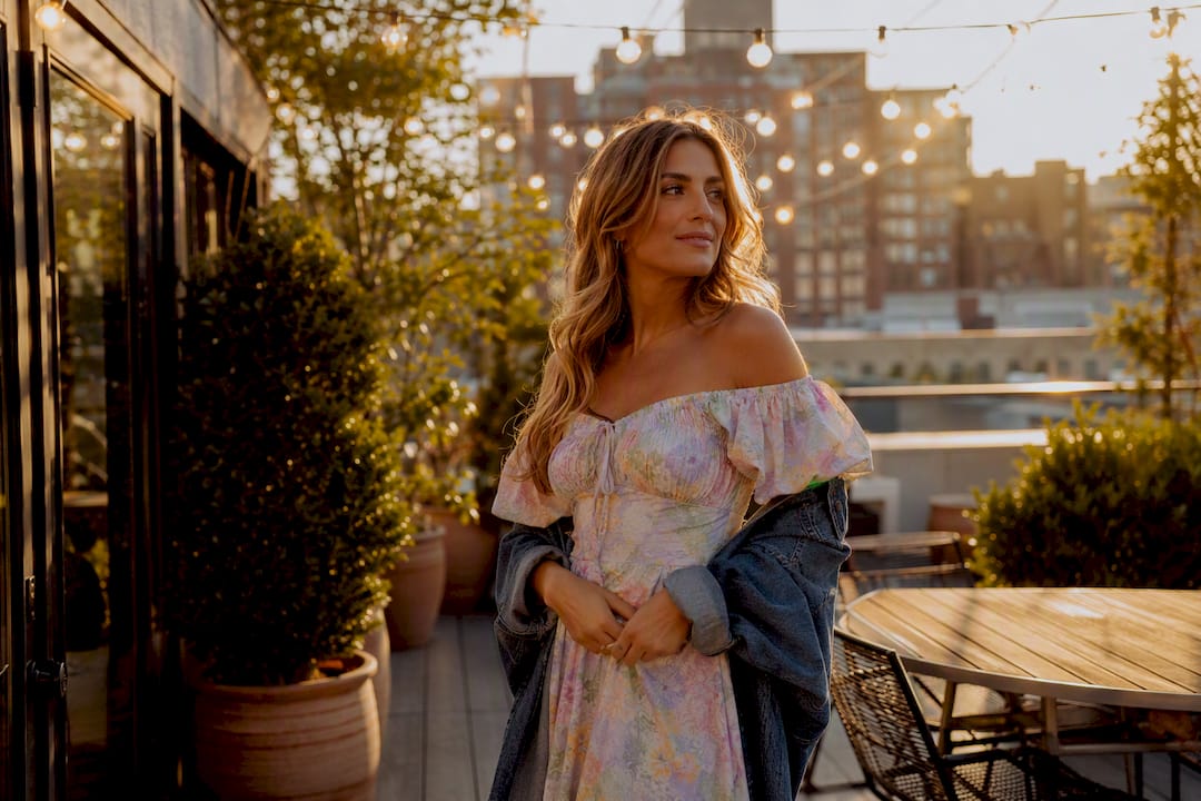 Woman wearing denim jacket over off-shoulder dress