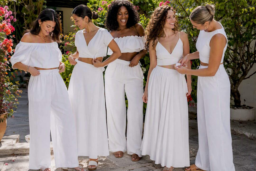 Diverse women adjusting white matching set fits