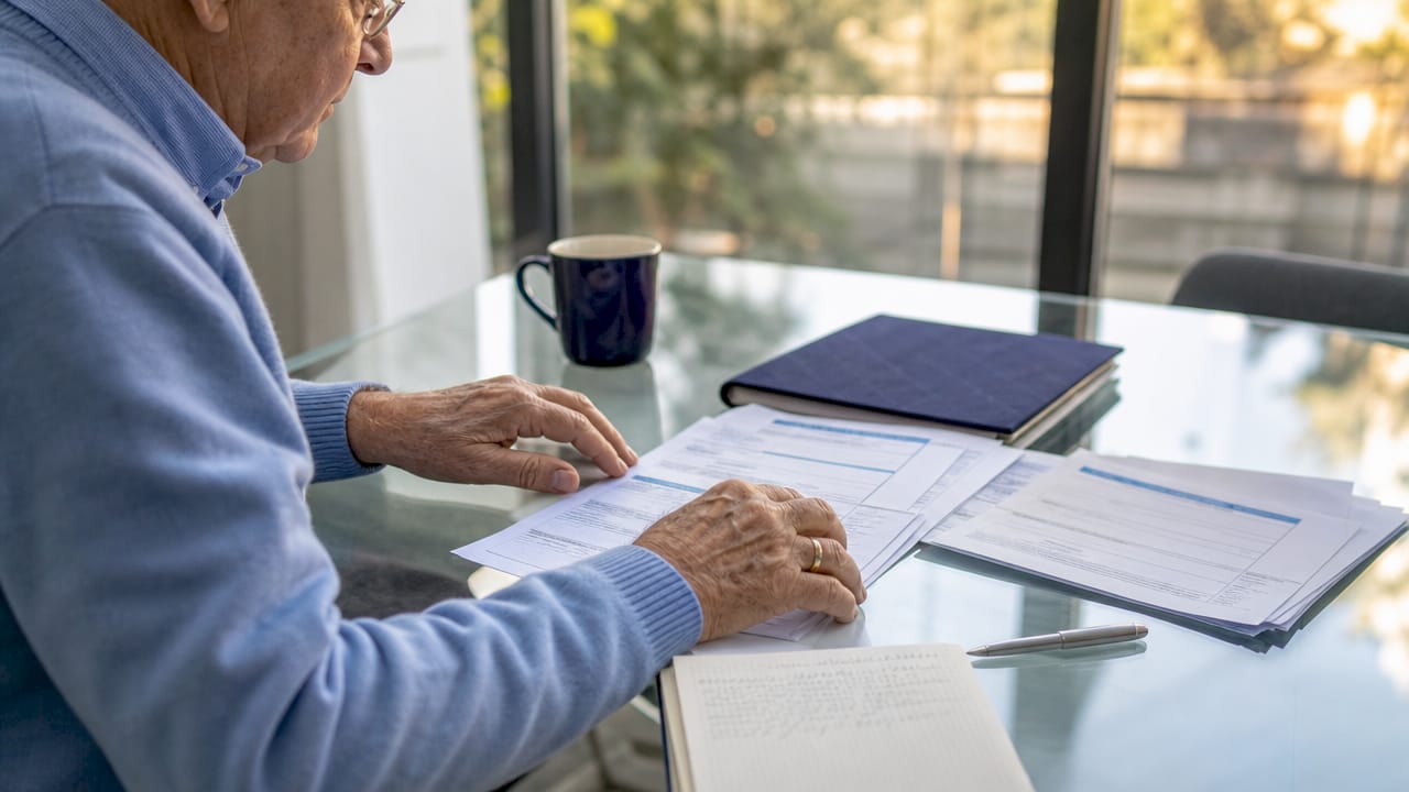 Hands holding Medicare hospital billing statements