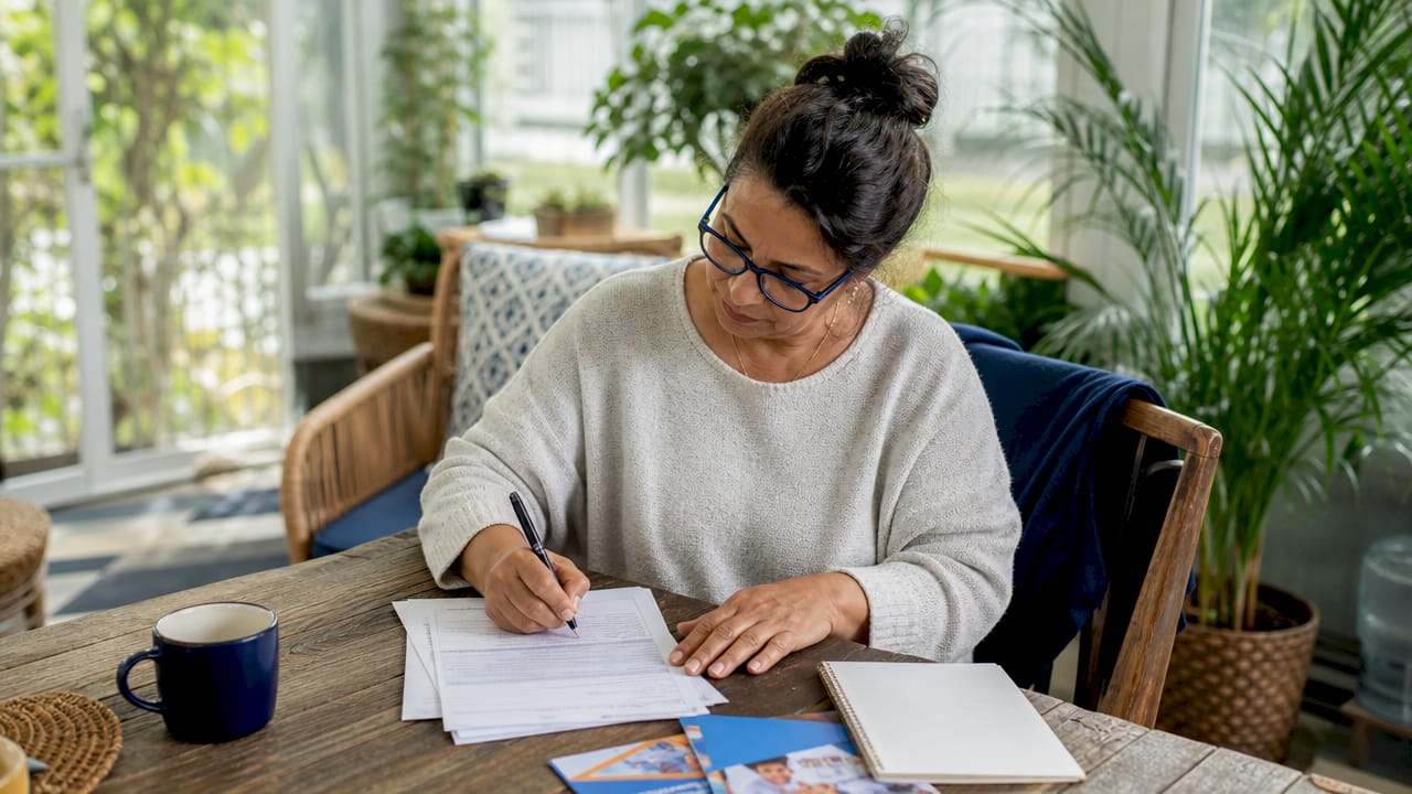 Woman completing Medigap enrollment form