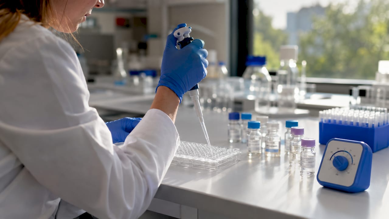 Hands pipetting signaling peptides for assay