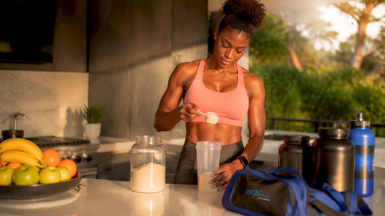Black female athlete measuring protein powder