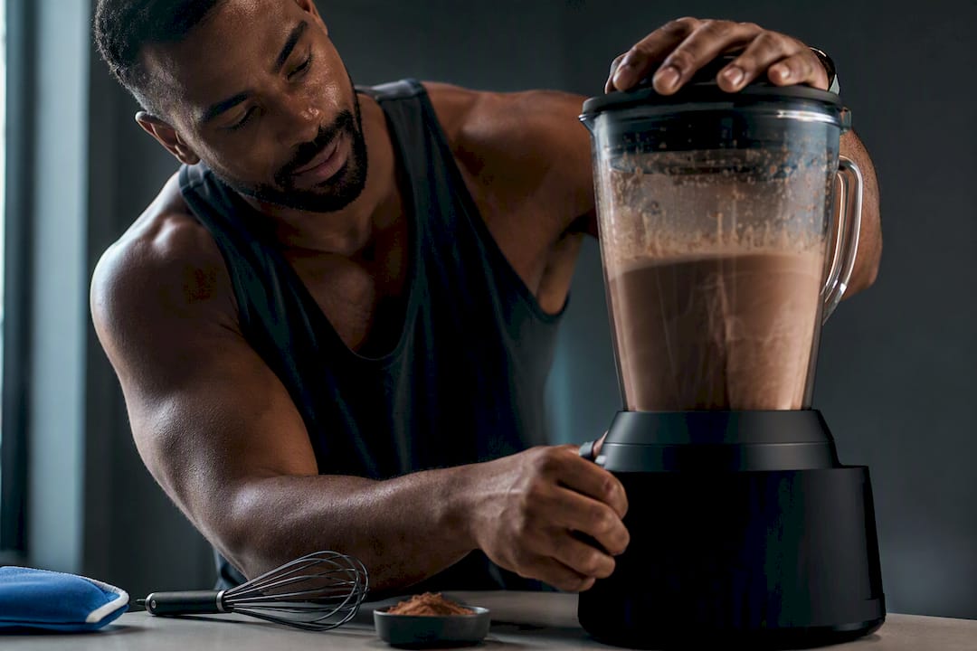 Black man blending grainy protein hot chocolate