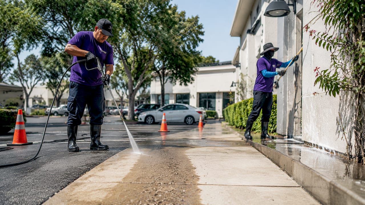 Cleaners using pressure washing and soft washing methods outdoors