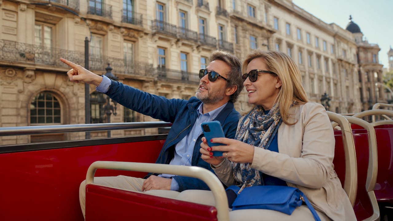 Couple enjoying hop-on hop-off bus tour
