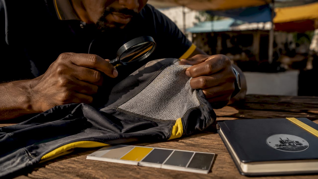 Hands inspecting breathable fleet work shirt fabric