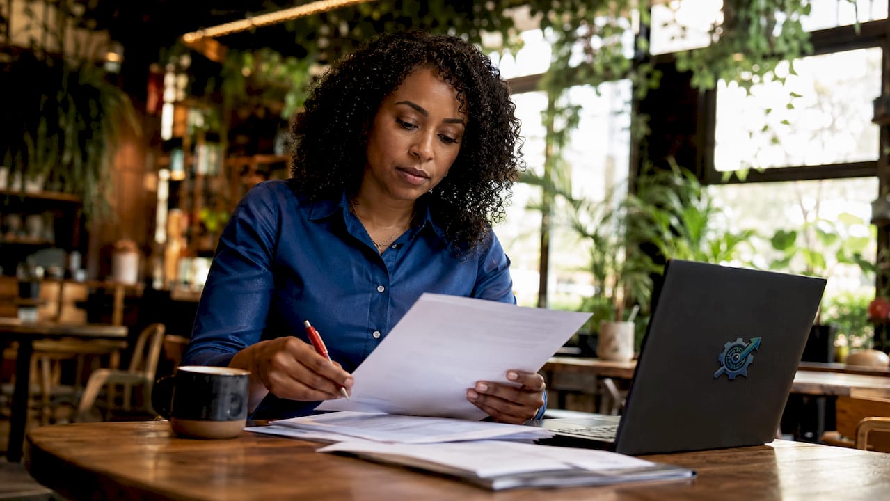 HR manager reviewing resumes at desk