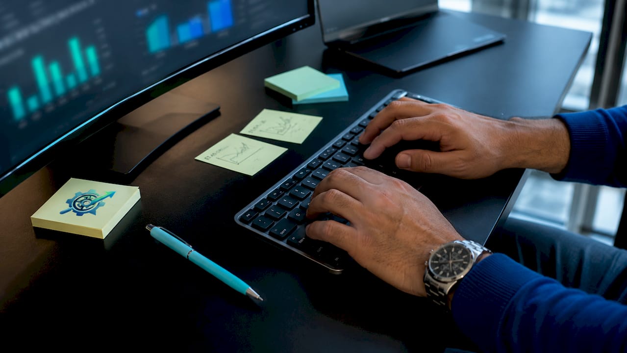 Close-up of hands typing on keyboard at recruitment desk