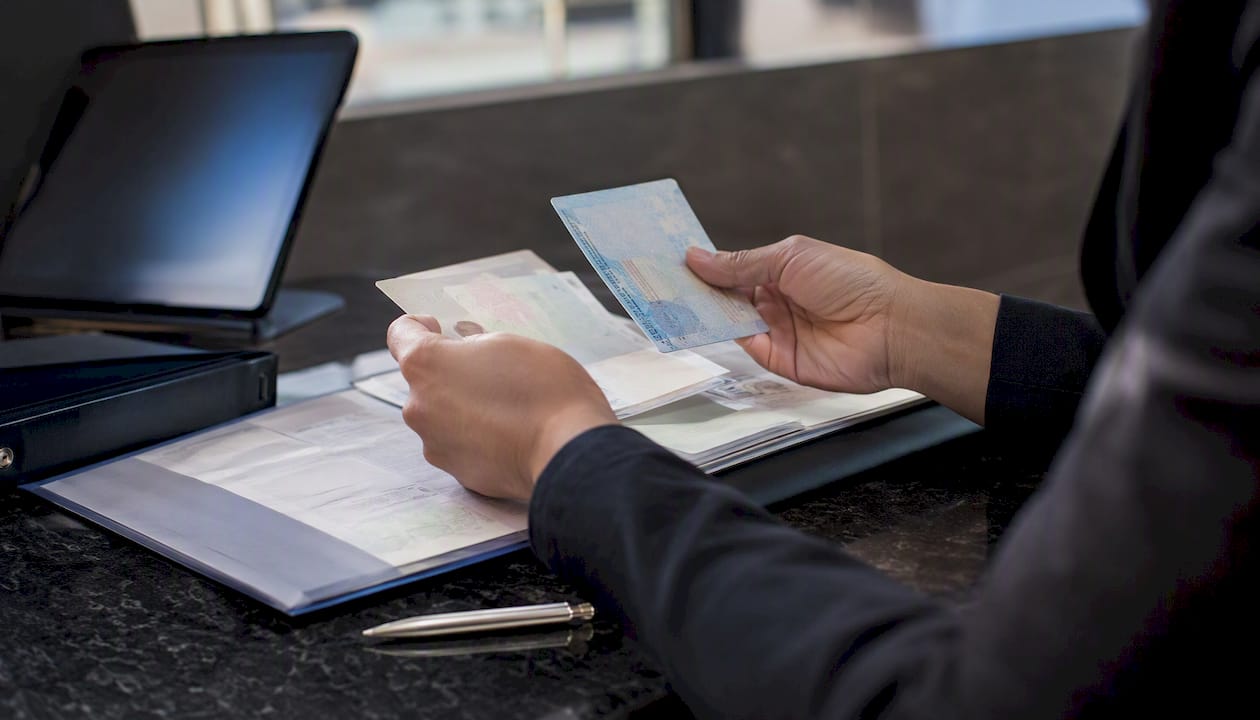 Hands inspecting I-9 documents carefully