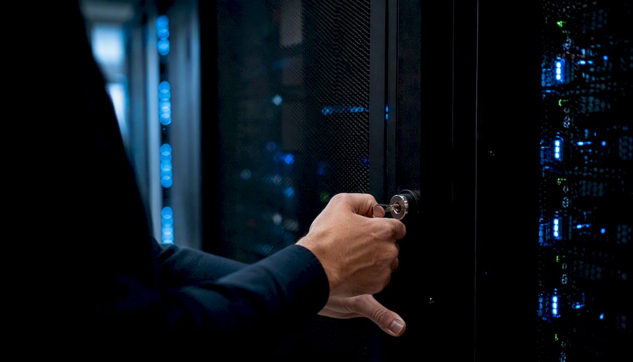Hands locking server rack in Canadian data center