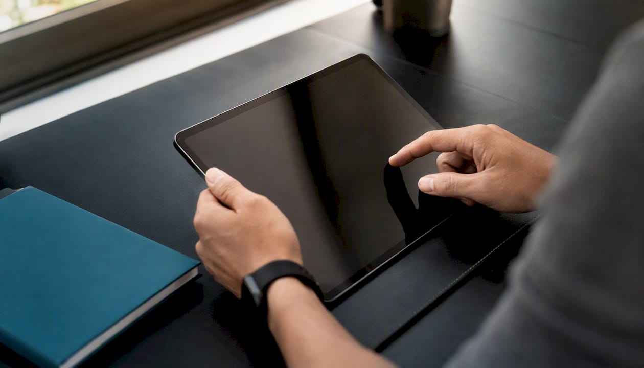 Hands handling device on dark desk
