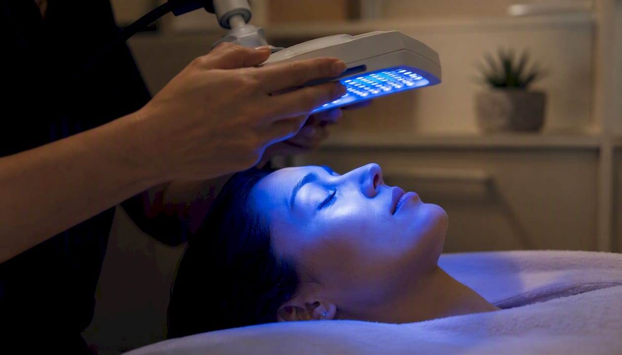 Clinician adjusting blue light therapy lamp